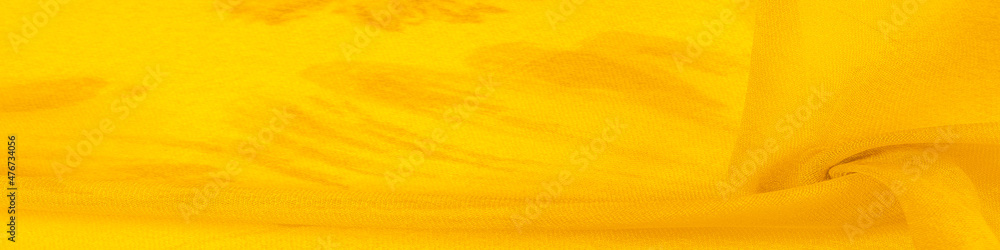 Background texture, yellow silk fabric with painted meadow flowers, colors between green and orange in the spectrum, the main subtractive color, painted like ripe lemons or egg yolks. - obrazy, fototapety, plakaty 