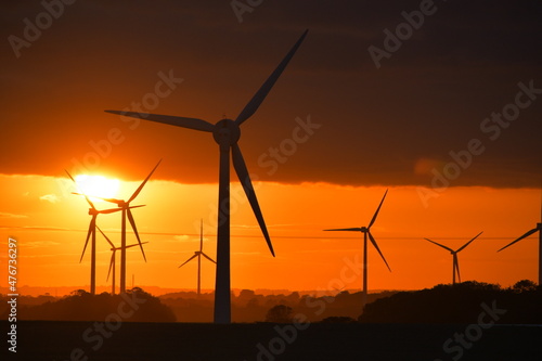 Bright sunset through wind turbine farm in East Yorkshire, UK