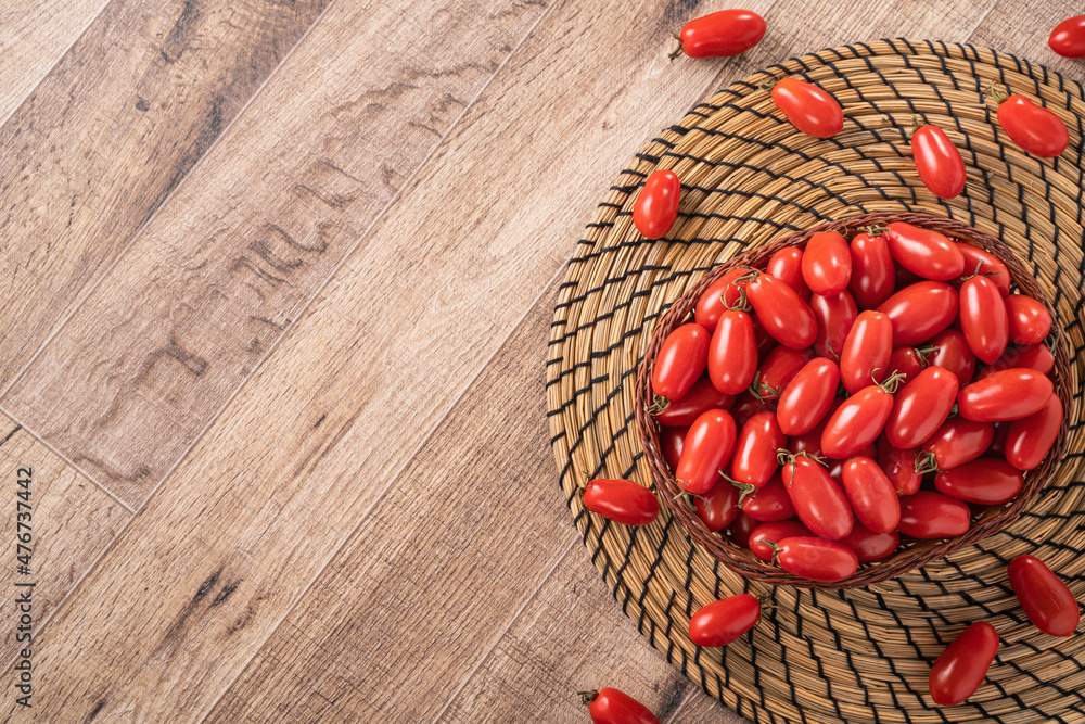 Fresh cherry tomatoes over wooden table background. Fresh cherry tomatoes over wooden table background.