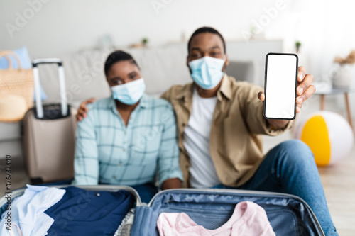 African American Couple Showing Phone Screen Indoor  Wearing Face Masks