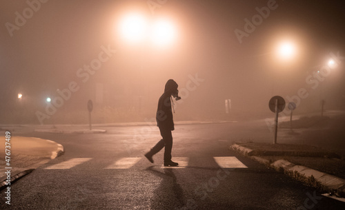 person in the fog gas mask walking  orange