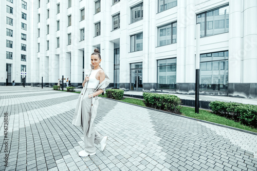 pretty young woman walking on the street. © Yulia