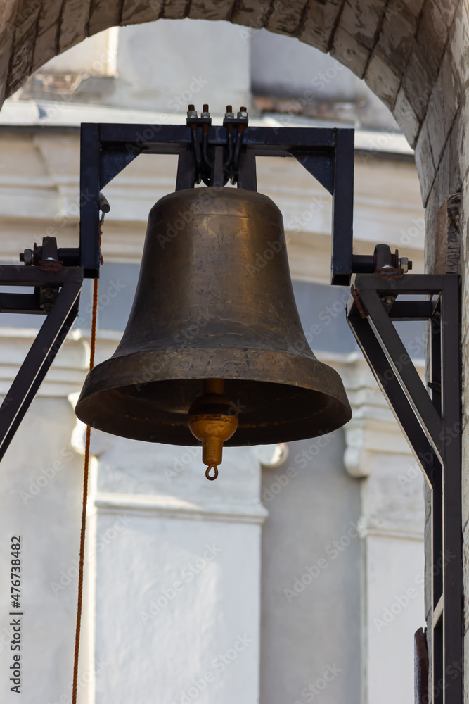 Large Church bell hanging outside. Close-up view of metal orthodox church bell