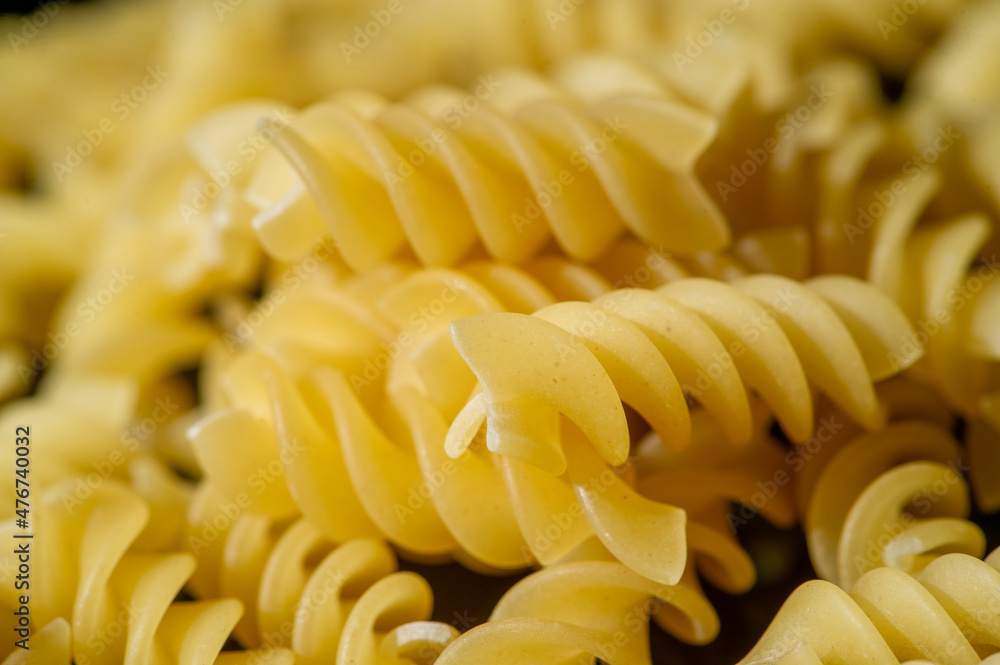 Short pasta. Fusilli, commonly known as rotini in the United States, is a variety of pasta that has a corkscrew or spiral shape. The word fusilli is believed to be derived from fuso (