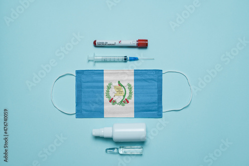 Blood tube for test detection of virus Covid-19 Omicron Variant with positive result, medicine mask with Guatemala flag superimposed and vaccine.  New Variant of the Covid-19 Omicron