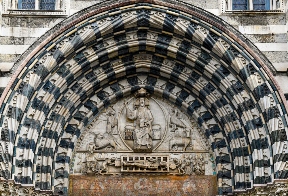 Lunette of the central portal of the Cathedral of San Lorenzo with Christ the Judge surrounded by the symbols of the four Evangelists and below, the Martyrdom of San Lorenzo, Genoa, Liguria, Italy - obrazy, fototapety, plakaty 