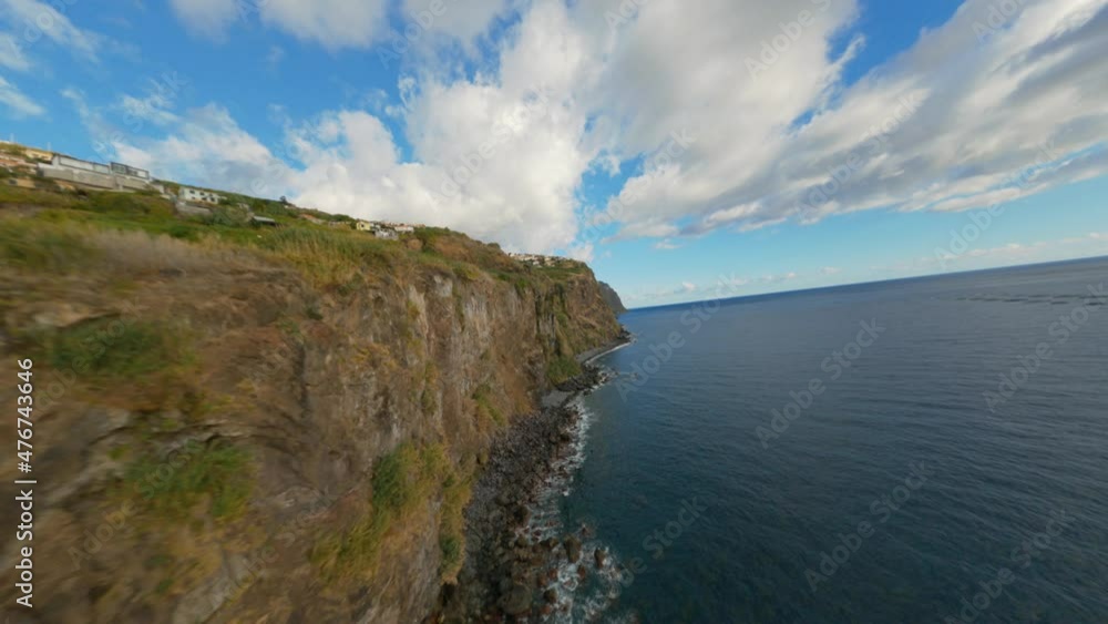 FPV racing drone shot in Madeira Portugal during golden hours. The drone will be diving down the cliffs and you can see how close it gets to the land. FPV racing drone shot in Madeira Portugal during golden hours. The drone will be diving down the cliffs and you can see how close it gets to the land.