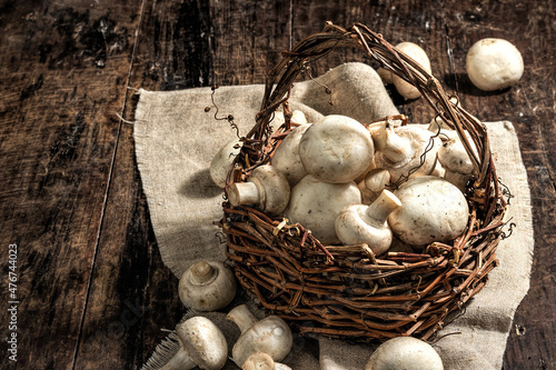 Fresh champignons in a basket. Raw ingredient for cooking vegan food