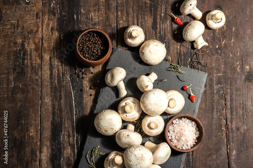 Fresh champignons with spices and herbs. Raw ingredient for cooking vegan food