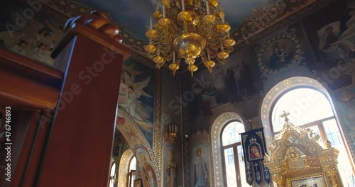 KYIV, UKRAINE � OCTOBER, 02, 2021 Kiev Pechersk Lavra Beautiful interior view incide  Christian Orthodox church. Tracking from bottom to top, golden altar and  chandelier on the ceiling.