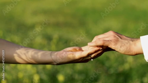 Closeup of woman and man holding lovely hands and moving away from each other