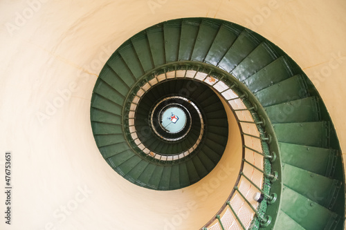 Upside view of stairs inside a lighthouse in the Norhtern Coast of France.