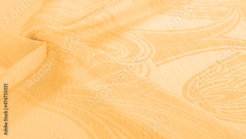 silk  cambric , cambric - very thin translucent soft mercerized fabric, amber yellow. Texture, background, pattern, sensation photo