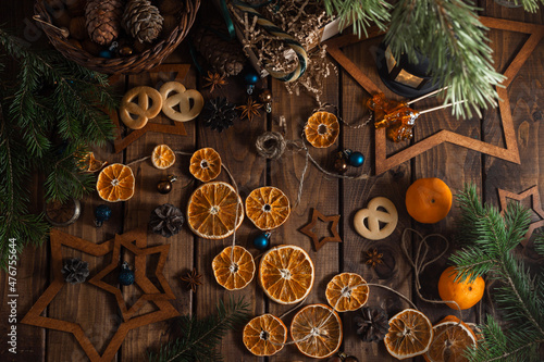 Dried slices of oranges cut into circles lie on a wooden table. New Year's Flatley