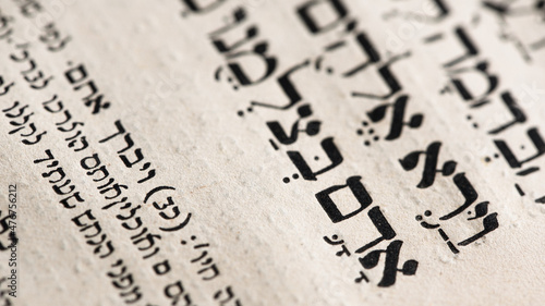 Fotografiet Closeup of hebrew word in Torah page that translates in english as Adam, Biblical figure