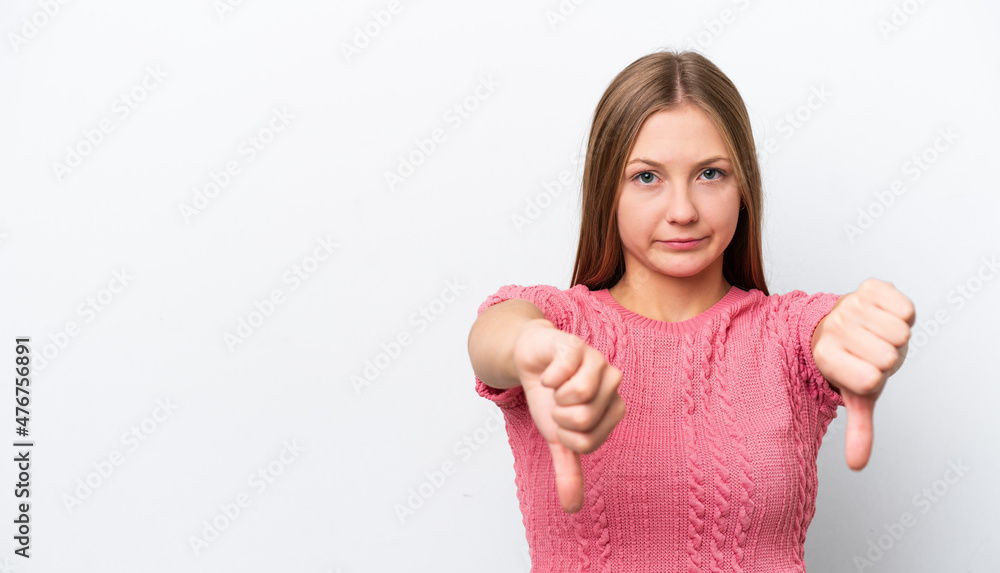 Young Russian woman isolated on white background showing thumb down with two hands Young Russian woman isolated on white background showing thumb down with two hands