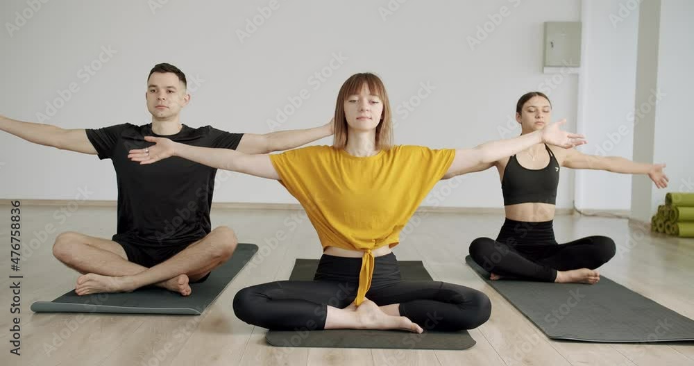 Young diversity sporty people practicing yoga lesson with instructor, Namaste Young diversity sporty people practicing yoga lesson with instructor, Namaste