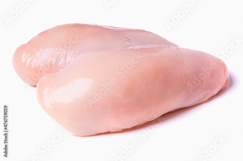 Whole raw chicken breast isolated on a white background