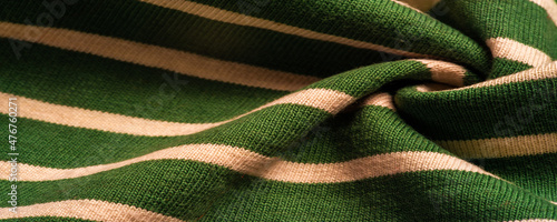 fabric from green and white woolen stripes, woolen knitwear that is elegant and pleasant to work with. Great for your projects. Texture, pattern