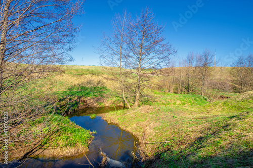 Photographs of a landscape, stream, Gully is a relief created by running water, which rapidly collapses into the soil, usually on a hillside. Gullies resemble large ditches or small valleys,