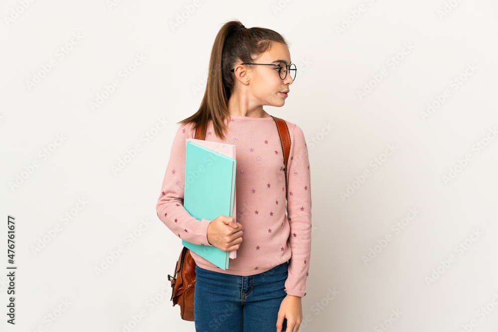 Little student girl over isolated background looking to the side Little student girl over isolated background looking to the side