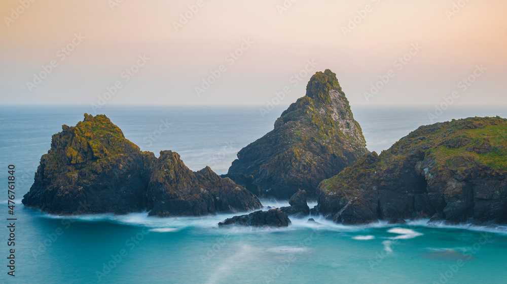 The coastline of Cornwall, England. A summers evening and the sky is glowing as the sun sets over the spectacular, rugged coastline