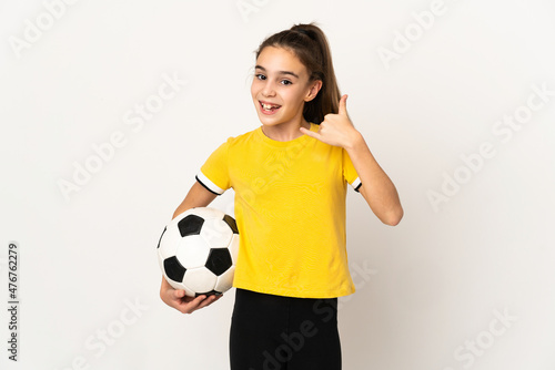 Little football player girl isolated on white background making phone gesture. Call me back sign © luismolinero