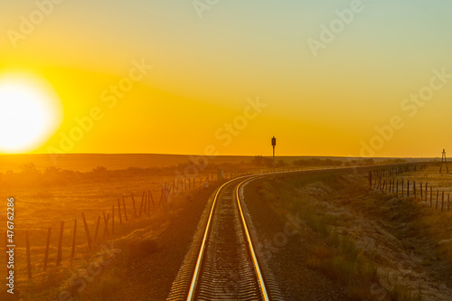 railway overpass. steppe. Railway landscape at sunrise. Summer sunny day. Sunset. dawn over the railroad tracks. © Татьяна Мищенко