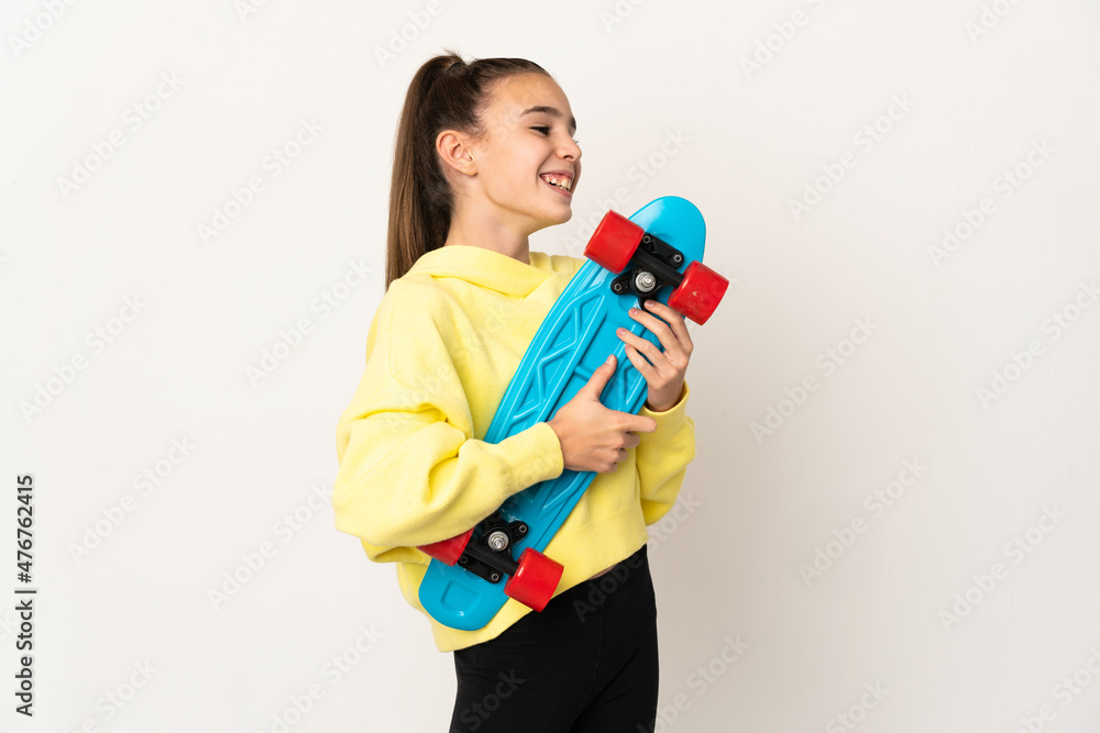 Little girl isolated on white background with a skate with happy expression Little girl isolated on white background with a skate with happy expression