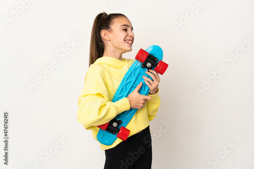 Little girl isolated on white background with a skate with happy expression