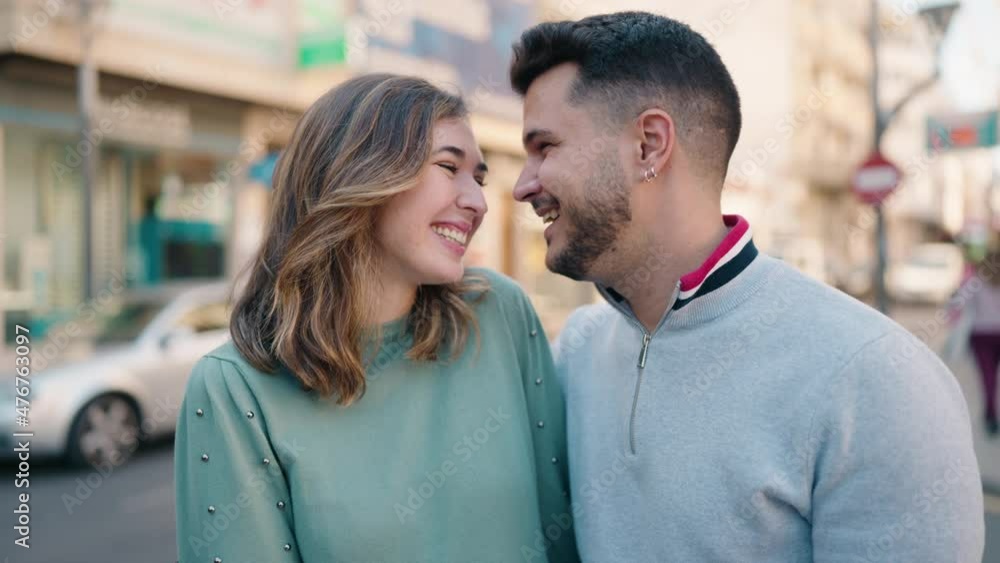Young couple smiling confident doing heart symbol with hands at street Young couple smiling confident doing heart symbol with hands at street