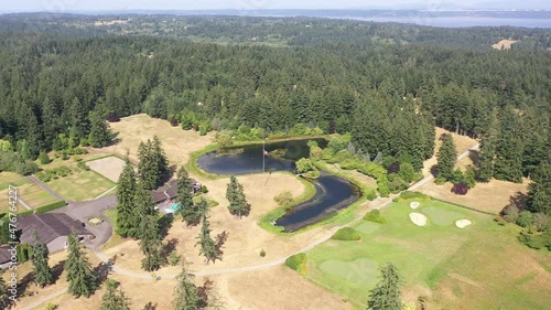 Cinematic aerial drone trucking shot of a cattle ranch farm on Maury Island with views of Vashon Island and Puget Sound in the Puget Sound, Pacific Northwest by Seattle, Washington photo