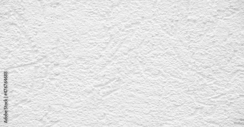 White plaster on the building. Plaster is a building material used for protective or decorative coating of walls and ceilings. After drying off from calcium carbonate, it turns white