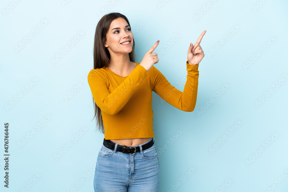 Young caucasian woman isolated on blue background pointing with the index finger a great idea Young caucasian woman isolated on blue background pointing with the index finger a great idea