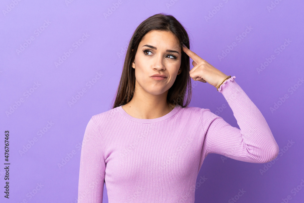 Young caucasian woman over isolated background making the gesture of madness putting finger on the head Young caucasian woman over isolated background making the gesture of madness putting finger on the head