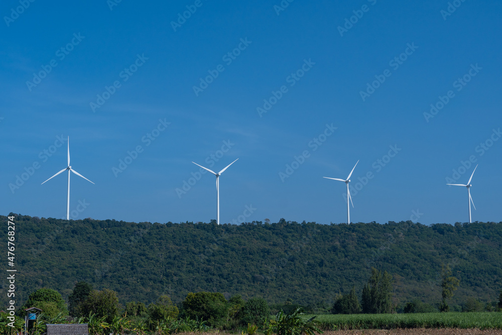 A sunny day of wind turbines generating electricity, Thailand. Clean energy from nature. A sunny day of wind turbines generating electricity, Thailand. Clean energy from nature.