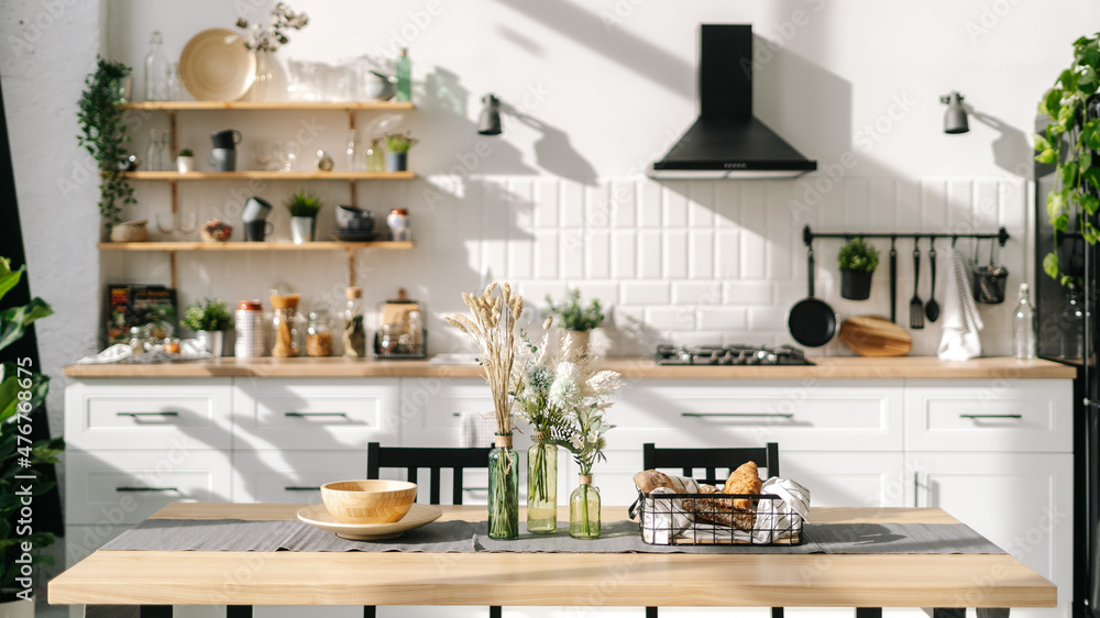 Fototapeta premium Spacious and bright kitchen interior with modern decorations and food