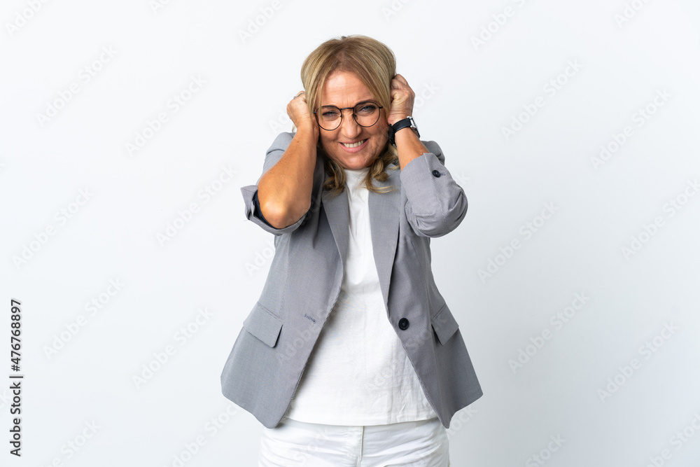 Middle aged business woman over isolated white background frustrated and covering ears