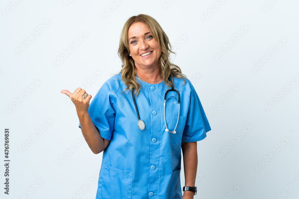 Middle aged surgeon woman over isolated background pointing to the side to present a product Middle aged surgeon woman over isolated background pointing to the side to present a product