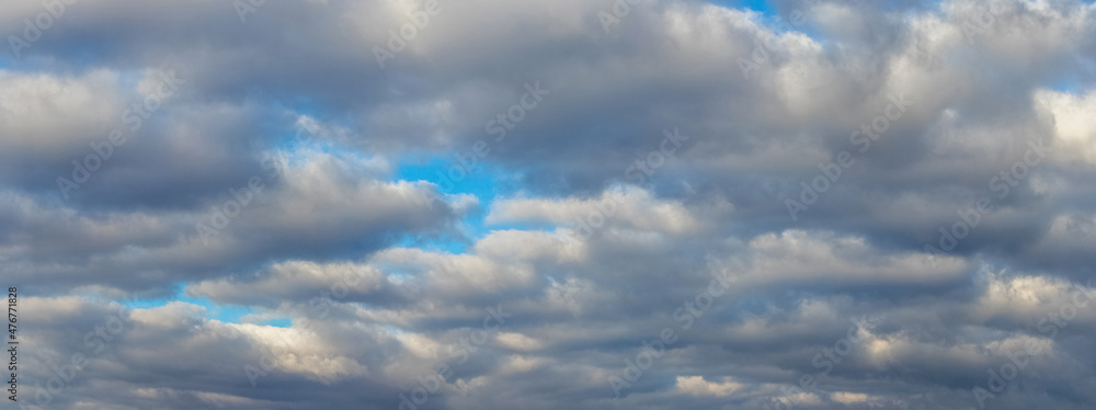 Blue sky with thick heavy clouds, the sky is densely covered with clouds