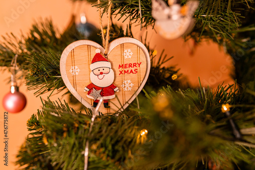 Beautifully decorated Christmas tree with different toys and symbols photo