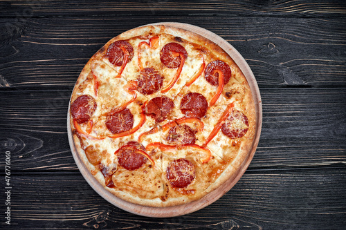 Hot pizza with Pepperoni Sausage on a dark background