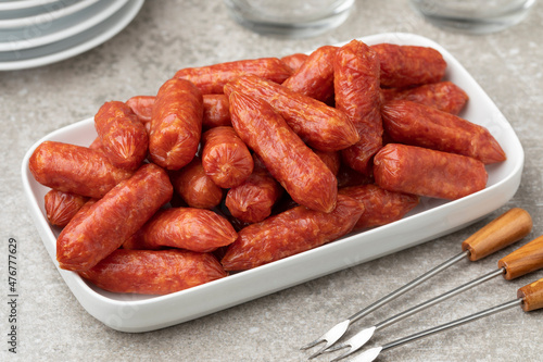 Plate with small Cabanossi sausages close up for a snack photo