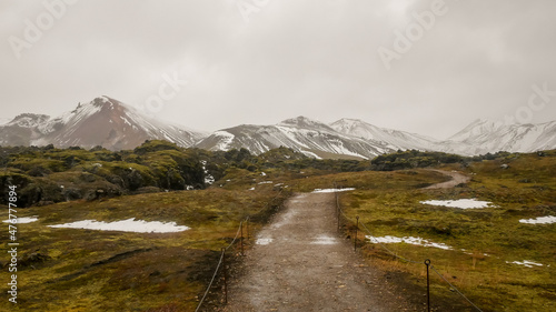 Hiking trail in Iceland towards the snow-capped mountains.