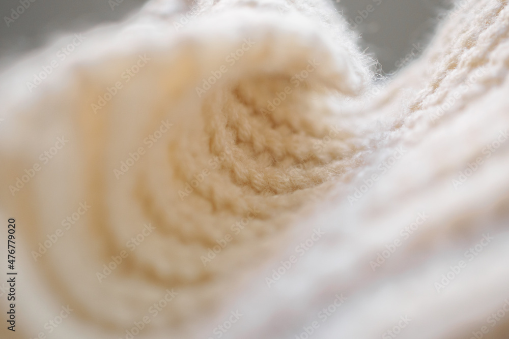 closeup beige knitted woolen fabric texture background closeup beige knitted woolen fabric texture background