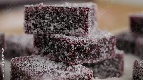 Close up. Homemade marmalade with sugar is on a plate. Dark red marmalade in sugar. Sliced homemade marmalade sprinkled with sugar.