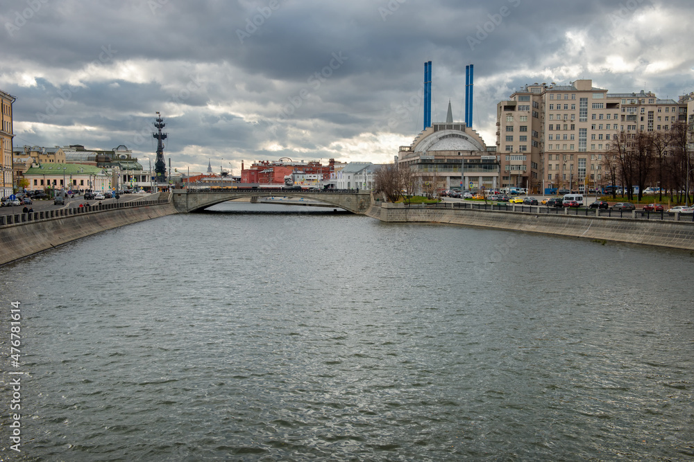 The house on the embankment, the Drainage canal, the Small Stone Bridge, the Udarnik cinema and the blue pipes of HPP-2. Urban autumn landscape The house on the embankment, the Drainage canal, the Small Stone Bridge, the Udarnik cinema and the blue pipes of HPP-2. Urban autumn landscape