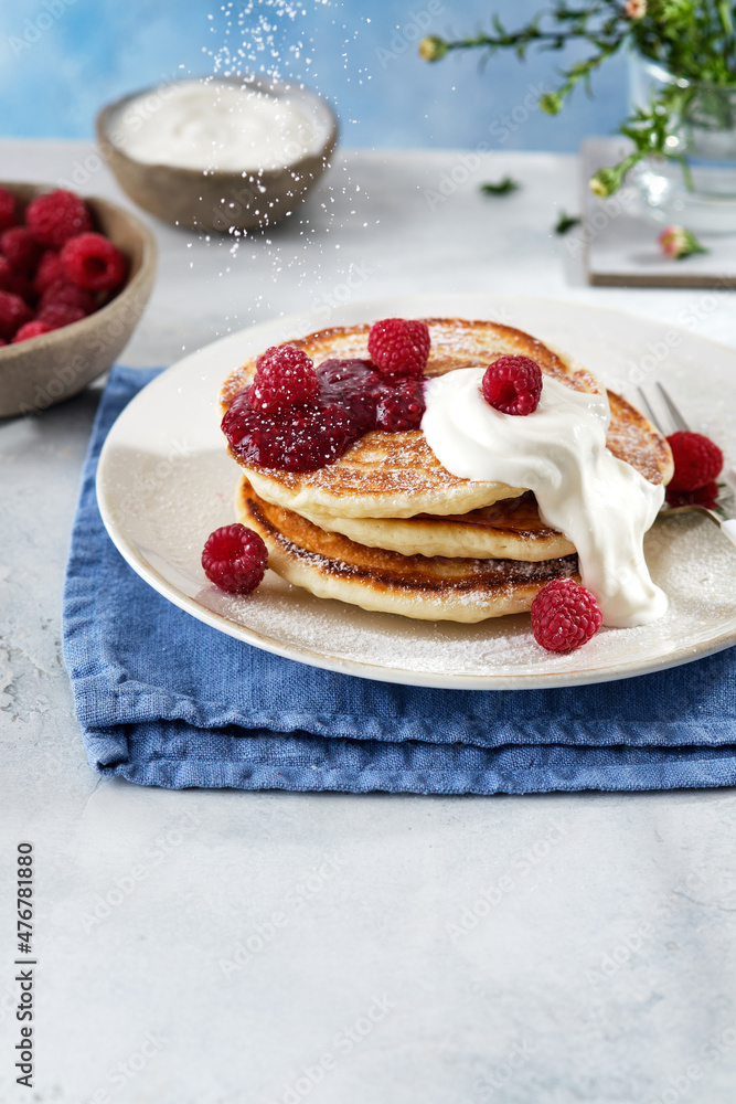 Pancakes for breakfast with sour cream, raspberry jam and fresh raspberries. Pancakes for breakfast with sour cream, raspberry jam and fresh raspberries.