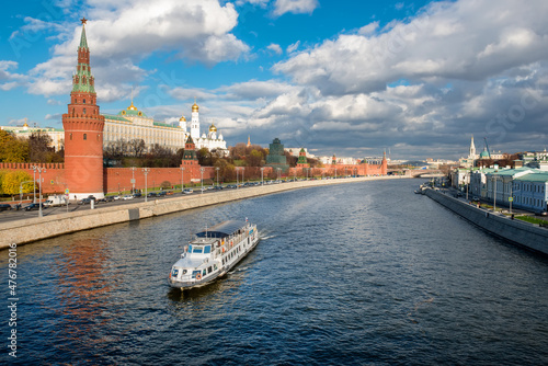 View of the Moscow Kremlin and pleasure cruise ship on the Moscow River on a autumn day