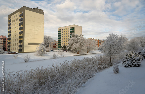 Buildings near a small lake in winter.